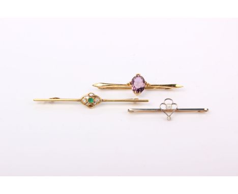 Three 9ct gold bar brooches. The first with central square cut emerald with single cut diamond accents. a pearl and collet se
