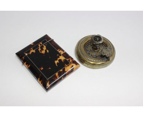 A tortoise shell card case, hinged lid with button release together with a small brass chamber stick. 