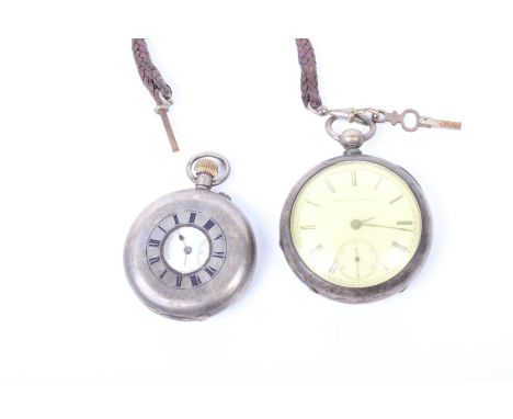 A sterling silver half hunter pocket watch, crown wind with white enamel face and roman numeral markers together with a key w