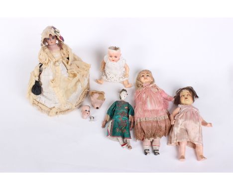 A collection of early to mid 20th Century dolls; including two ceramic doll heads with blue glass eyes,  a Heubach Koppelsdor