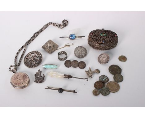 A collection of white metal and silver items to include a filigree and enamel oval pill box, a Victorian locket, three coin b