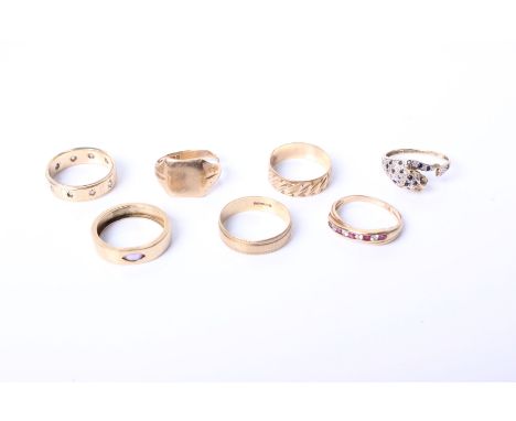 Seven 9ct gold gold rings. To include to four gold bands, one set with marquise cut amethyst, a signet ring a line set ruby a