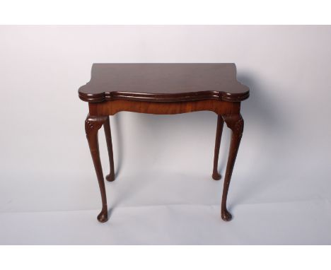A mahogany card table on shell carved cabriole legs bearing 'Shaw of London' label 74cm high, 92cm wide, 77cm deep 