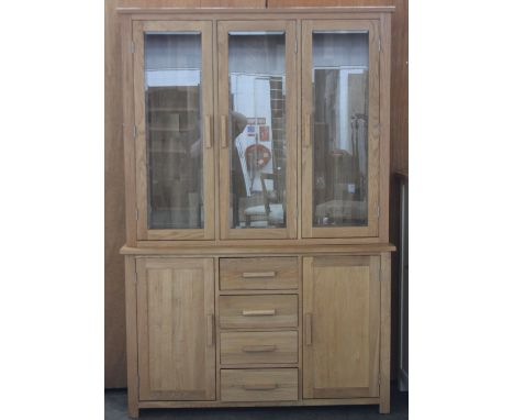 Solid light oak, glazed top cabinet, with four drawers and two cupboards.H: 195cm, w: 131cm, d: 43cm