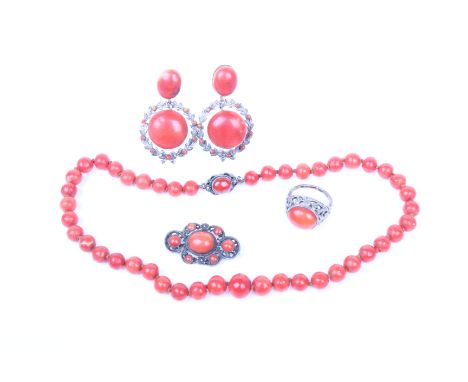 A suite of red coral jewellery to include a coral bead necklace graduating from 7mm to 11mm beads on a white metal clasp, a p