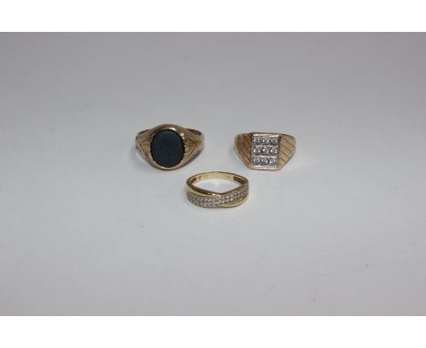 Three 9ct gold rings. the first with oval onyx panel the others set with diamond chips. 10g 