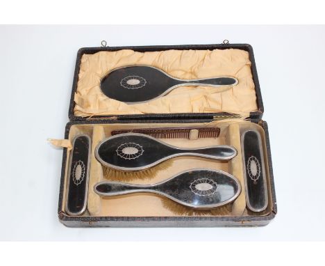 A sterling silver and tortoise shell dressing table set. Complete set to include hand held mirror comb and brushes (6) in fit