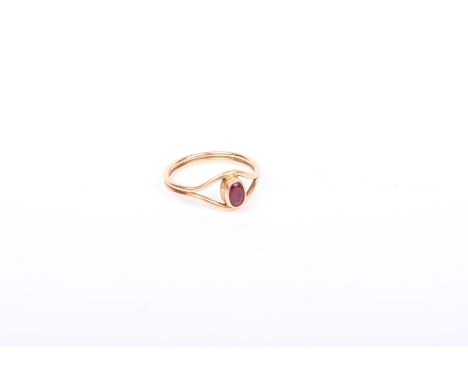 A 9k gold ruby ring. Central oval free cut ruby in a rubover setting.  size P. 2.6 g