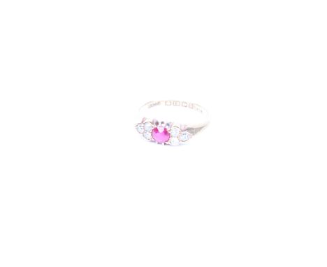 An 18ct gold  synthetic ruby and diamond ring. Birmingham 1912. round cut central ruby with three old cut diamonds to each sh
