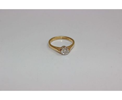 An 18k gold and diamond single stone ring. Central brilliant cut diamond in an eight claw setting. Size K Approximate diamond