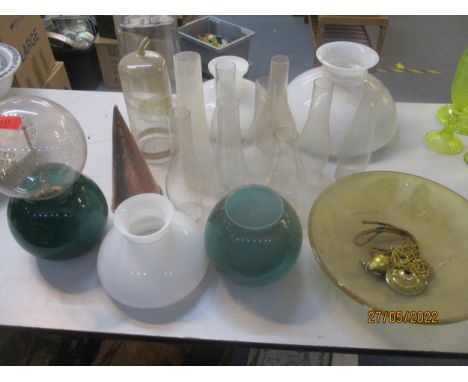 A mixed lot of glass light shades, smoke funnels, and other items to include an amber glass ceiling shade decorated with butt