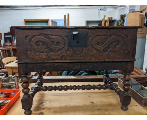 An 18th century oak bible box with carved ornament, on a later bobbin turned stand, 50cm h, 67 cm w 