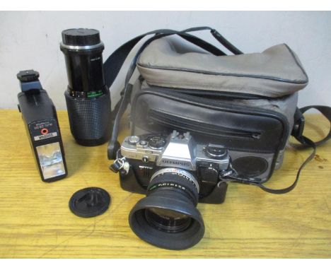 An Olympus OM10 camera with a 1:1.8 lens, and a Mitakon Zoom 1:5.6 85-300mm lens 