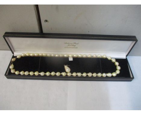 A cultured pearl necklace with a 9ct gold clasp and an earringLocation: CAB 