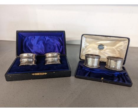 Two cased pairs of early 20th century napkin rings to include an engine turned pair, hallmarked Birmingham 1910Location: 