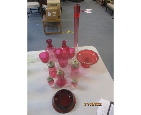 A selection of Victorian cranberry and ruby glass to include a spill vase, carafes, sugar casters and a Craven A ashtray 