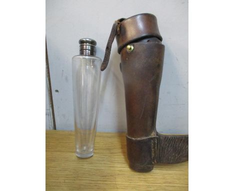 A late 19th/early 20th century tapered glass hunting flask with a silver plated top, housed in a leather case with straps 