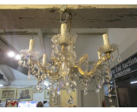 A gilt metal and glass six branch ceiling chandelier with faceted glass drops (podium /ceiling) 
