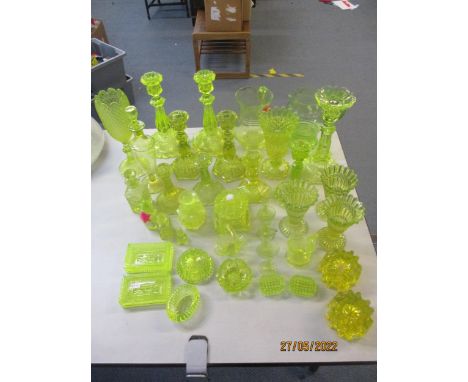 A collection of Victorian and early 20th century pressed and blown uranium table glass to include various candlesticks, jugs,