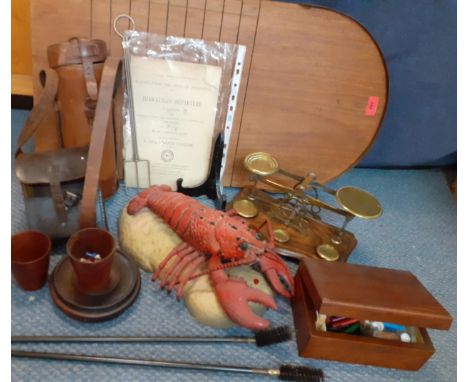 A vintage lot comprising a shove ha'penny board, postal scales, music sheets, a singing novelty lobster, leather cases, treen