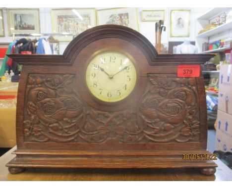 An early 20th century cased mantle clock decorated with Arts &amp; Crafts floral decoration, white enamel Arabic dial 
