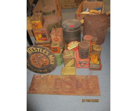 A mixed selection of vintage tins to include a 1914 WWI Christmas tin, wall clock advertising Nestle's Milk, and a cast iron 