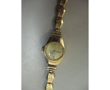 A 9ct gold ladies MuDu manual wind wristwatch on a 9ct gold strap, 12.3gLocation: 