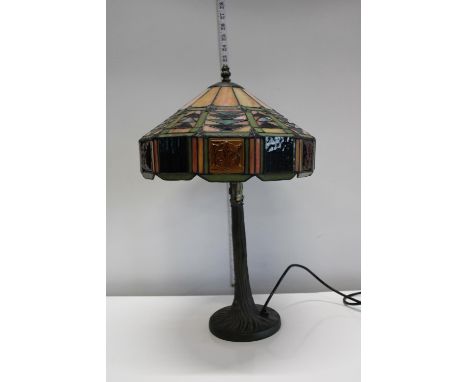A Tiffany style table lamp on a metal base 