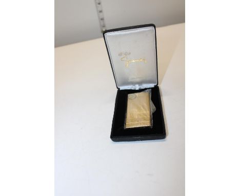 A boxed Givenchy gold plated lighter 
