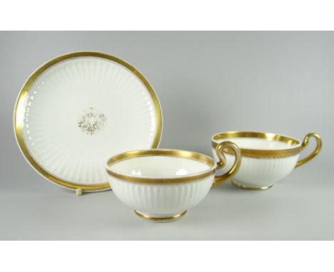 TWO SWANSEA PORCELAIN PARIS FLUTE TEACUPS &amp; SAUCER one teacup with shallow bowl the other with deeper, gilded rims, handl