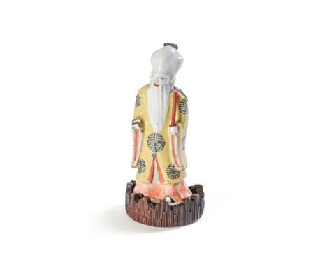 A CHINESE FAMILLE ROSE FIGURE OF SHOULAO       19TH CENTURY     Mounted on an associated wooden stand      Overall height 28c