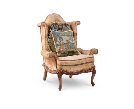 A CARVED WALNUT AND UPHOLSTERED WINGBACK ARMCHAIR IN 18TH CENTURY STYLE  EARLY 20TH CENTURY 112cm high, 87cm wide, 77cm deep 