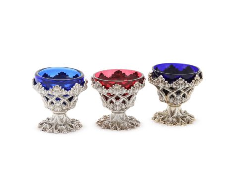 A MATCHED SET OF THREE SILVER PEDESTAL SALTS, IN THE GOTHIC TASTE HENRY WILKINSON & CO., SHEFFIELD 1836, 1837 AND 1844 With p