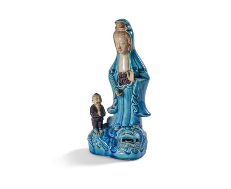 A CHINESE TURQUOISE AND AUBERGINE MODEL OF GUANYIN     19TH CENTURY OR EARLY 20TH CENTURY With boy attendant 30cm high       