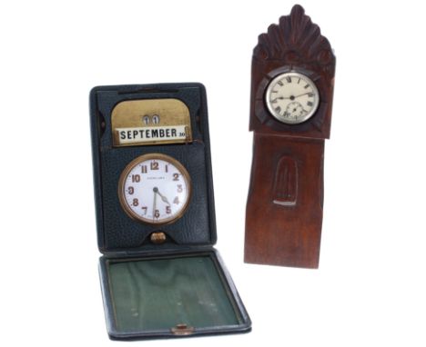 Swiss travel clock and day/date calendar within a green travel case, the clock dial branded 'Finnigans', the travel case 6'' 