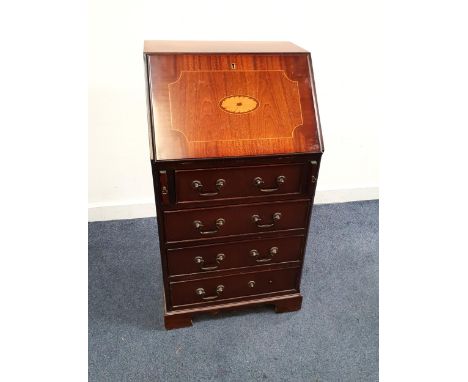 SMALL MAHOGANY VENEERED BUREAUthe fall flap opening to reveal fitted interior with single drawer, about four drawers and rais
