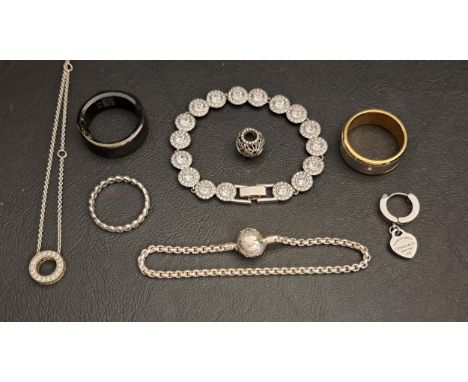 SELECTION OF FASHION JEWELLERYcomprising a Pandora silver logo pave circle necklace, a Pandora silver ring and charm, a Swaro