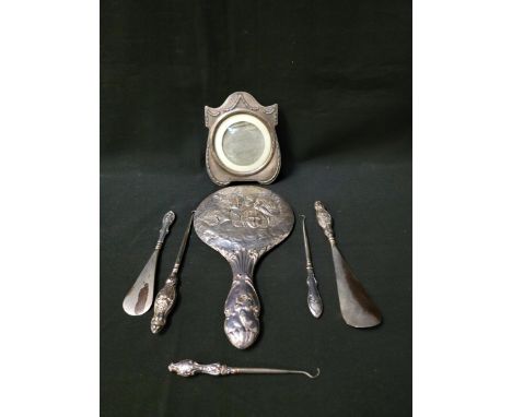 SELECTION OF SILVER ITEMScomprising a silver backed dressing table mirror with embossed cherub decoration, Birmingham 1913; a