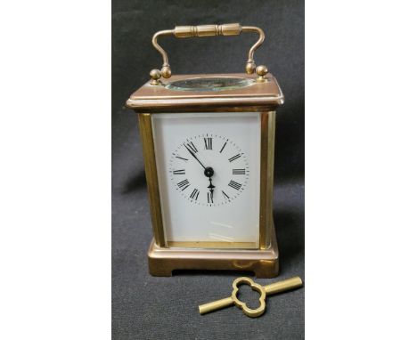 BRASS CASED CARRIAGE CLOCKthe white enamel dial with Roman numerals, complete with key, 12cm high