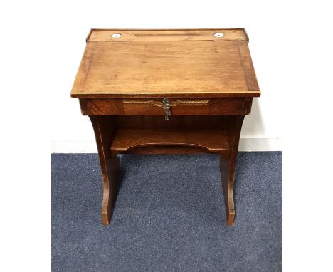 SMALL ANTIQUE CLERK'S DESK the lockable top with pen recess, flanked by two inkwells, and opening to reveal storage within, w