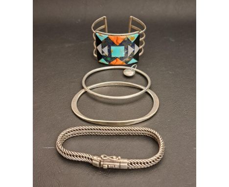 THREE SILVER BANGLES AND A BRACELETcomprising a stone set Native American bangle, maker mark MWT, two further bangles, one wi