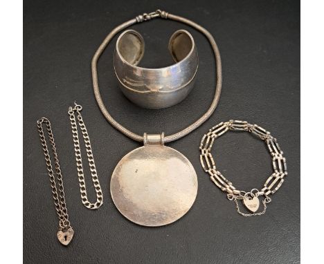 SELECTION OF SILVER JEWELLERYcomprising a cuff bangle, a gate bracelet with padlock clasp, a large unmarked silver disc penda