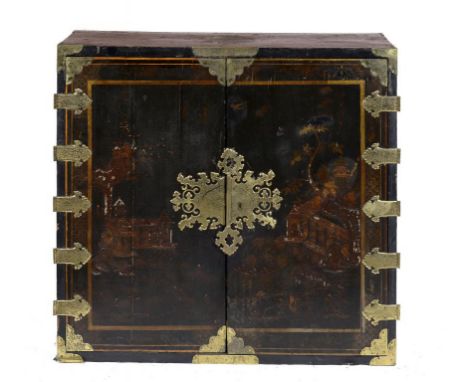 A WILLIAM III BLACK JAPANNED CABINET, C1700  with engraved brass mounts, the interior fitted with drawers, substantial brass 