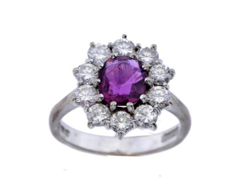 A RUBY AND DIAMOND CLUSTER RING  in 18ct white gold, London 1975, 5.8g, size N ++An attractive ring in fine condition, the ru