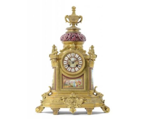 A FRENCH ORMOLU MANTLE CLOCK, LATE 19TH C inset with Sèvres  style claret ground porcelain plaques, the 'jewelled' dial and p