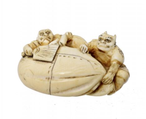 A JAPANESE IVORY NETSUKE, MEIJI PERIOD  of two oni with a large sack, Meiji period, 4cm w ++In fine condition 