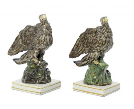 A PAIR OF STAFFORDSHIRE PEARL GLAZED EARTHENWARE MODELS OF EAGLES, C1820  with overglaze enamel painted decoration, 20cm h ++