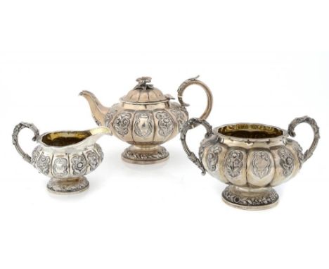 A WILLIAM IV SILVER MELON SHAPED TEA SERVICE  crisply chased, the teapot with flower knop, 16.5cm h, by William Hunter, Londo