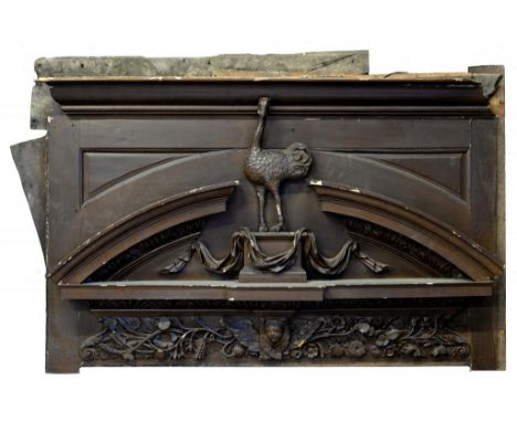 AN ENGLISH CARVED AND PAINTED PINE DOORCASE, MID 18TH C  the segmental cornice centred by an ostrich standing on a draped ped