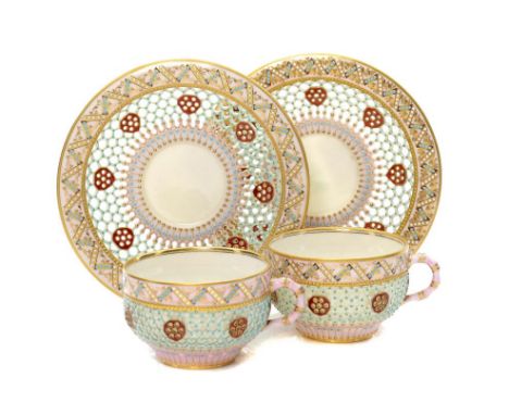 TWO ROYAL WORCESTER HONEYCOMB RETICULATED CABINET CUPS AND SAUCERS, 1877 AND CIRCA the double walled cup with bamboo handle, 